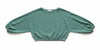 Green textured blouse on a hanger against a beige wall.
