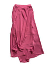 Pink skirt on a white surface with a blurred background