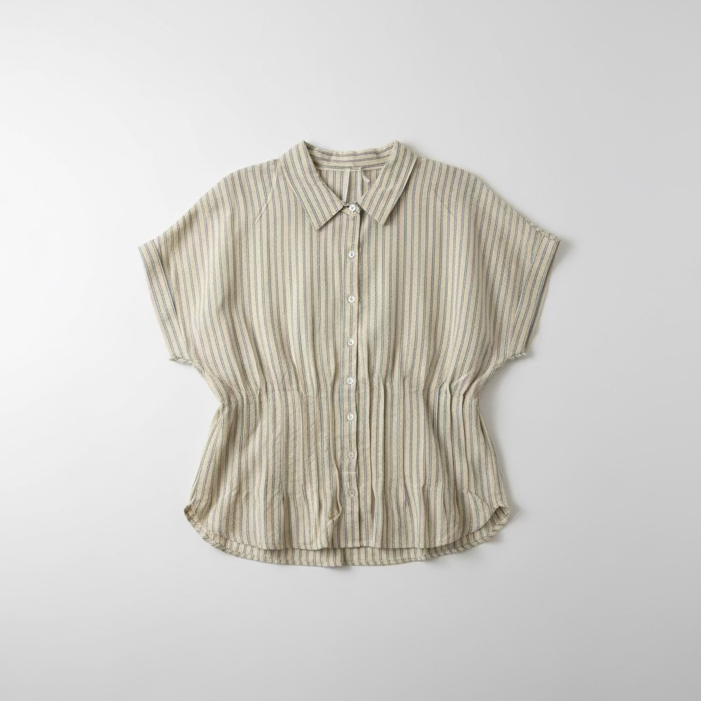 Striped shirt hanging on a hook against a white wall.