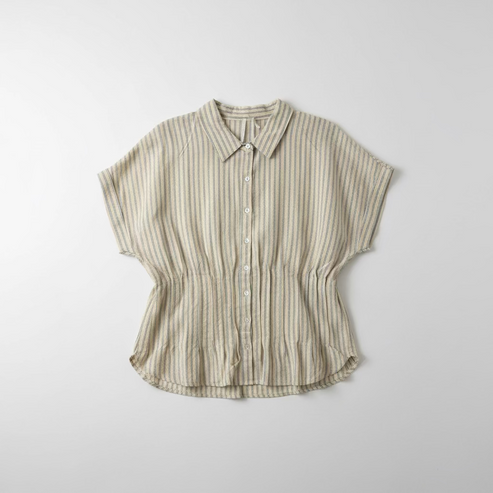 Striped shirt hanging on a hook against a white wall.