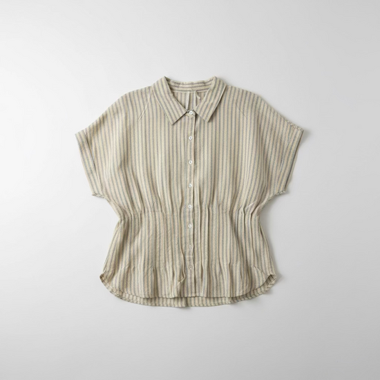 Striped shirt hanging on a hook against a white wall.