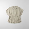 Striped shirt hanging on a hook against a white wall.