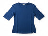 Blue t-shirt on a hanger against a white wall