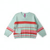 Light blue sweater with red and pink stripes on a hanger against a beige wall.