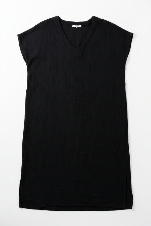 Black sleeveless dress on a hanger with a white background