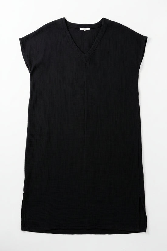 Black sleeveless dress on a hanger with a white background