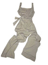 Beige overalls on a white surface with a blurred background